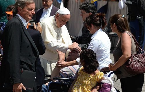 Pope Francis greets pilgrims in St. Peter's Square during the Wednesday General Audience May 21
