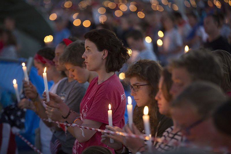 World Youth Day pilgrims hold candles during eucharistic adoration with Pope Francis at the July 30 prayer vigil at the Field of Mercy in Krakow