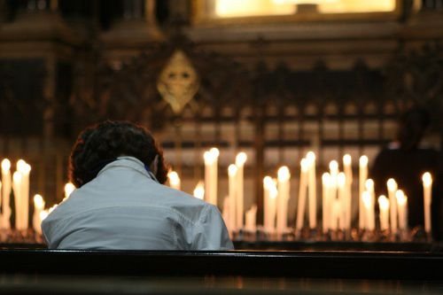 Woman praying in Milan