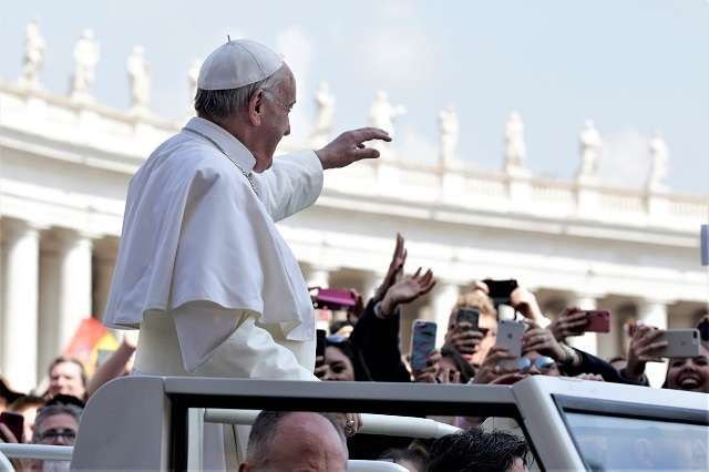 Pope Francis waves to pilgrims in St. Peter's Square on Easter Sunday April 16