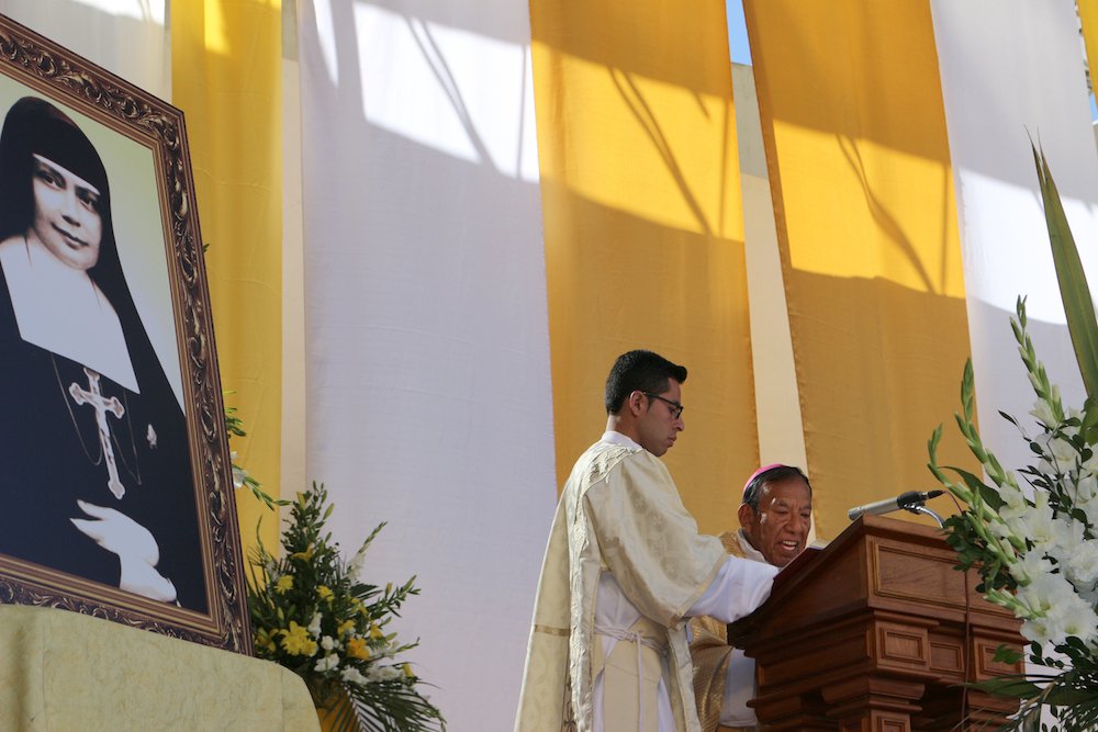 A portrait of Blessed Nazaria Ignacia March Mesa is seen as Bolivian Cardinal Toribio Ticona Porco celebrates Mass in La Paz
