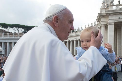 Pope Francis kisses a baby at the general audience in St. Peter's Square on Oct. 7
