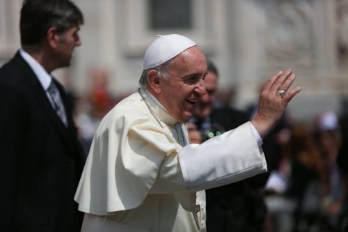 Pope Francis waves to the crowd gathered in St. Peter's Square for the Wednesday General Audience on May 27