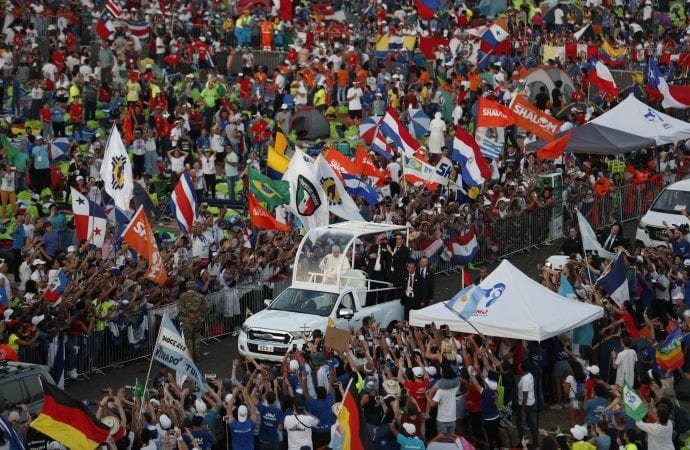 Pilgrims greet Pope Francis as he arrives for a vigil at Campo San Juan Pablo II in Panama City