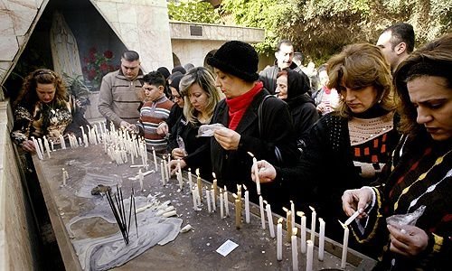 Iraqi Christians light candles affter attencing Christmas Mass in Baghdad on Dec. 25