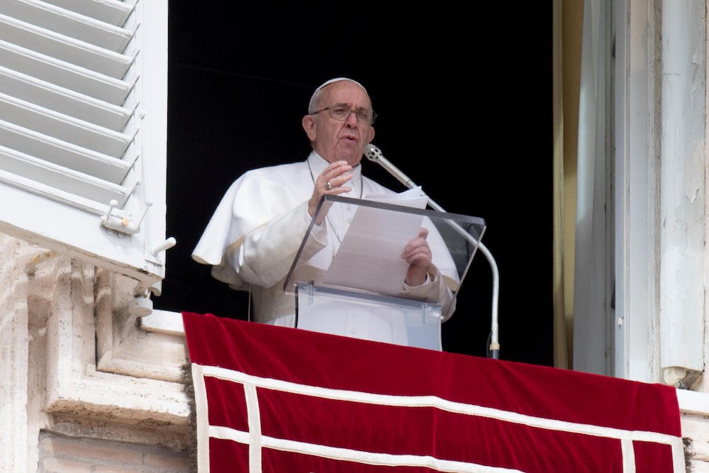 Pope Francis leads the Angelus from the window of his studio overlooking St. Peter's Square at the Vatican March 17