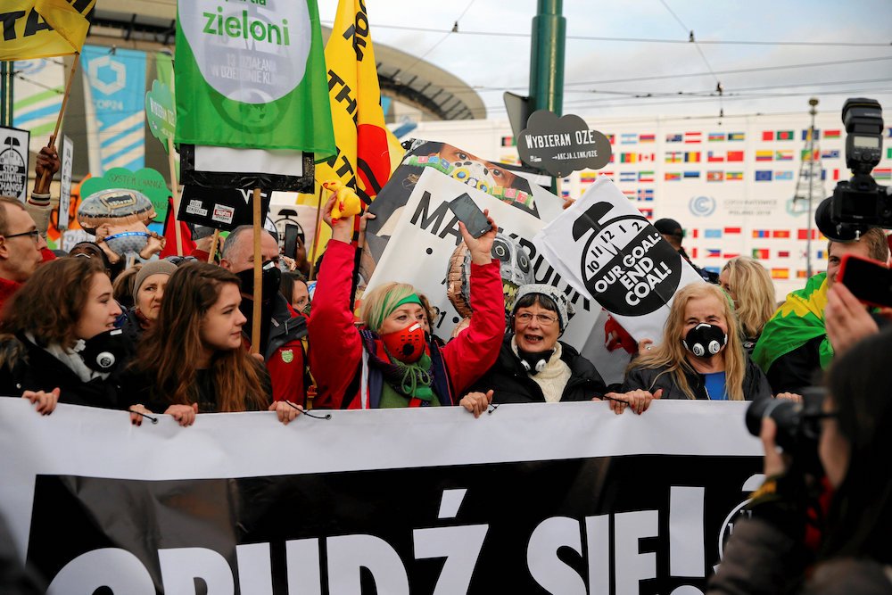 Protesters march outside the venue of the U.N. climate change conference