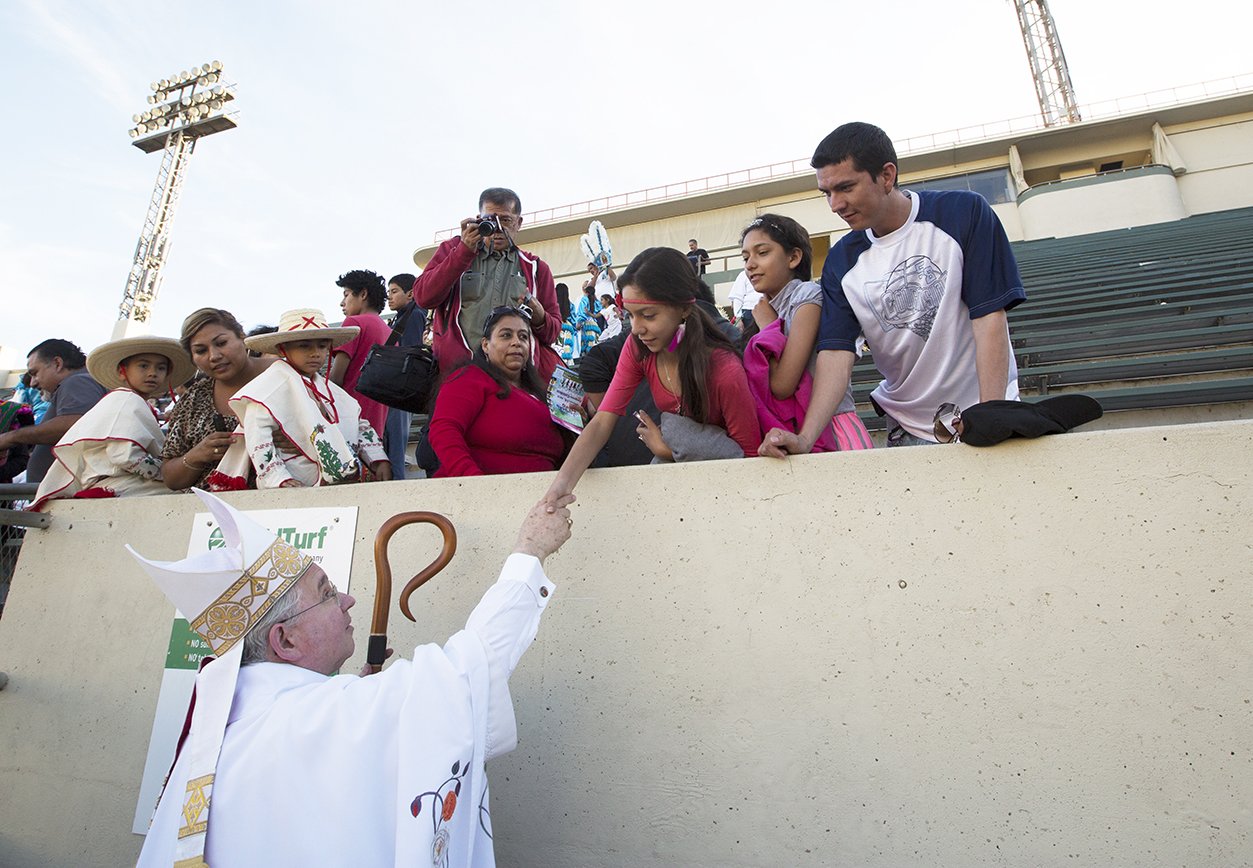 Archbishop Gomez greets young people at the annual procession in honor of Our Lady of Guadalupe in East Los Angeles in 2015. (VICTOR ALEMÁN/ANGELUS NEWS)