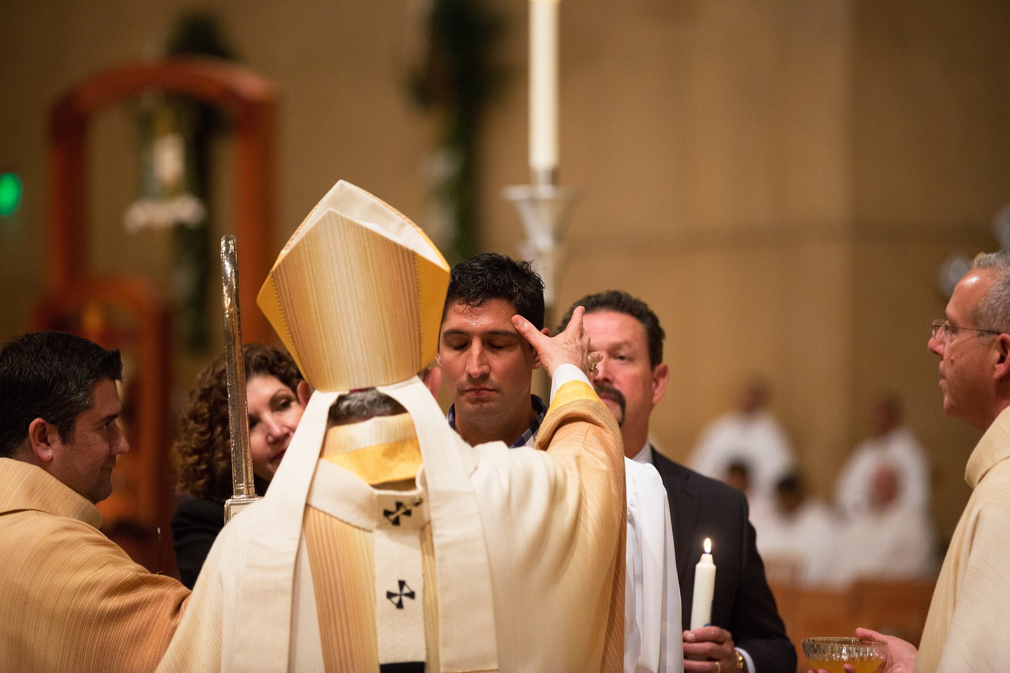 A catechumen is anointed with holy oil by Archbishop Gomez at the 2015 Easter Vigil. (VICTOR ALEMÁN)