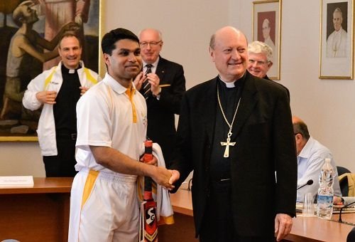 A member of St. Peter's Cricket Club greets Cardinal Gianfranco Ravasi during a June 23