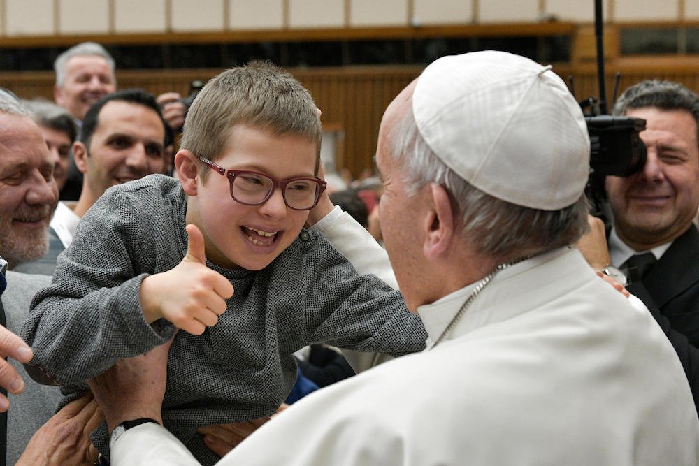 Pope Francis greets a child during an audience with members of Italy's Association Against Leukemia