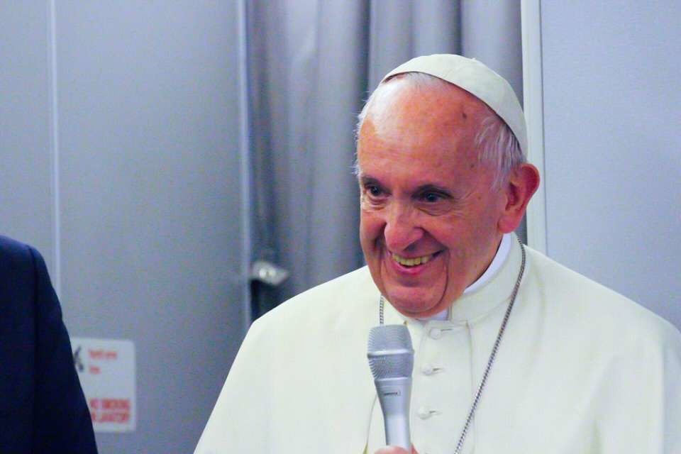 Pope Francis conducts a press conference aboard the papal plane