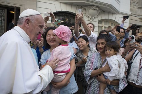 Pope Francis greets a mother and daughter during a special meeting with sick children in New York City