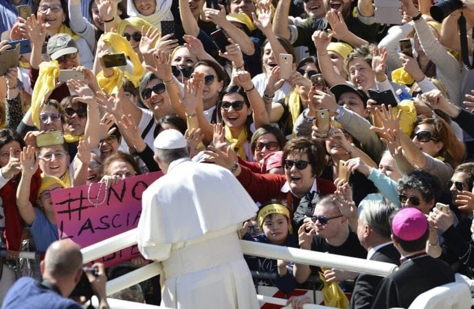 Faithful wave and reach out to Pope Francis upon his arrival at Loreto's cathedral
