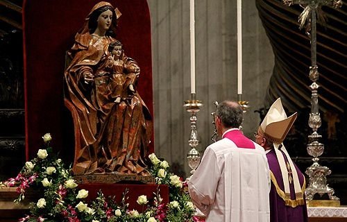 Pope Francis prays before a statue of Mary in St. Peter's Basilica on Nov. 30