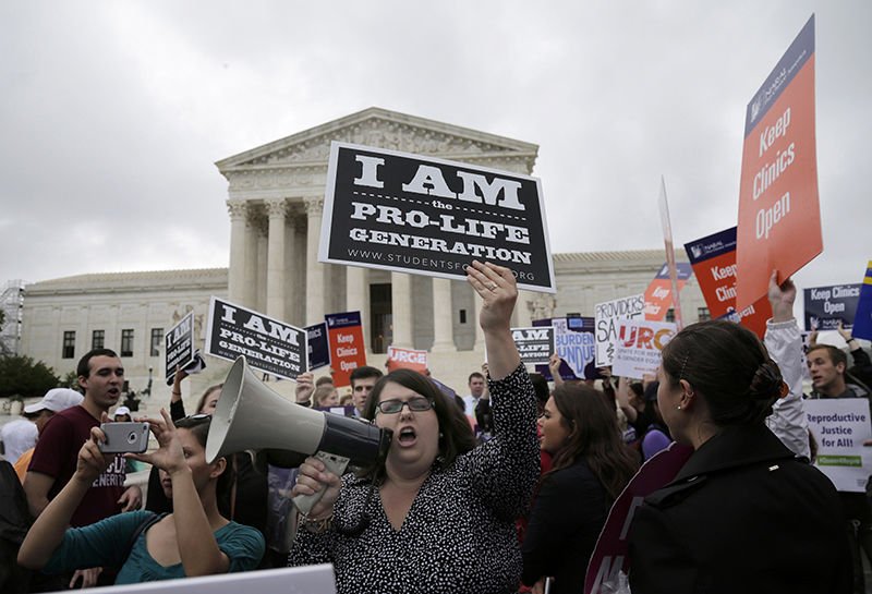 A pro-life supporter yells into a megaphone in front of the U.S. Supreme Court June 23. (photo/Andrew Gombert
