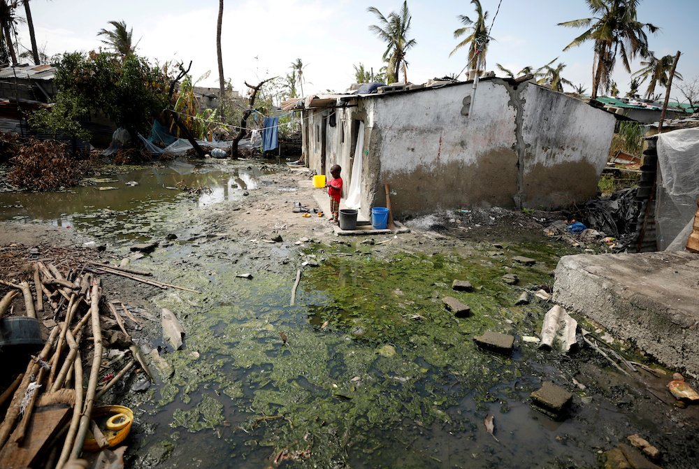 A child stands outside his home in Beira