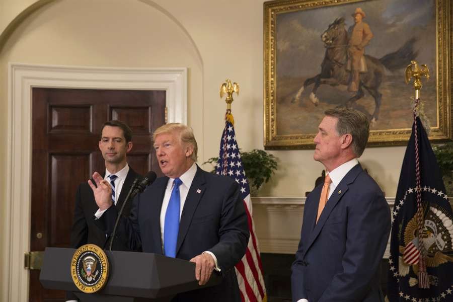 Trump announces introduction of the RAISE Act with Senator Tom Cotton (R Ark. left) and Senator David Perdue (R Ga.) at the White House