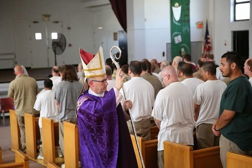 Bishop James Conley of Lincoln blesses prisoners at the Nebraska State Penitentiary during the recessional of a Mass said March 31
