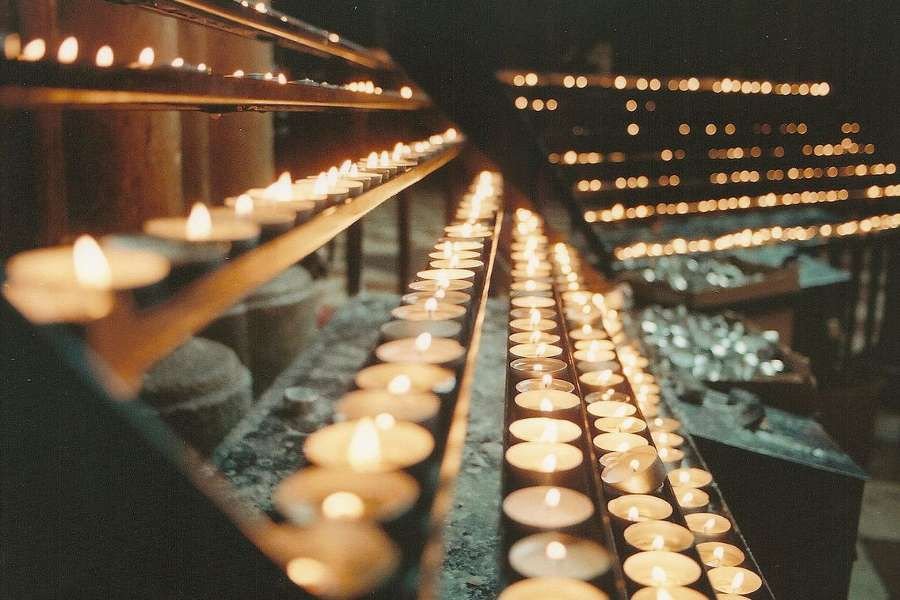 Prayer candles. Credit: Grey World via Flickr (CC BY 2.0).
