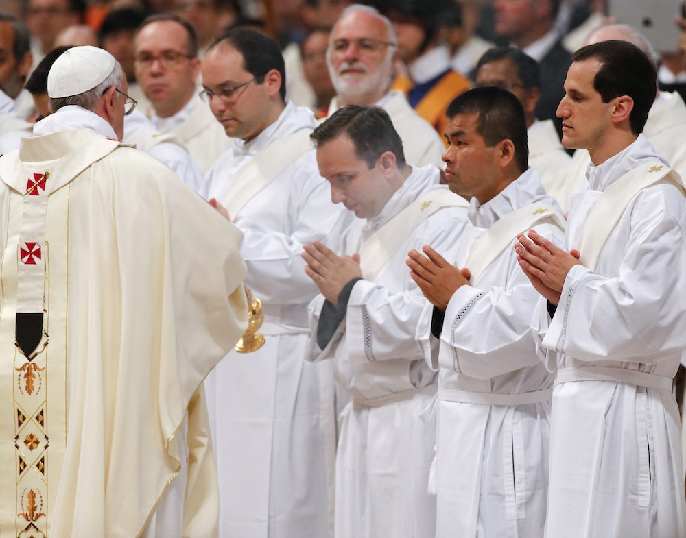 Pope Francis uses incense to bless new priests before their ordination Mass in St. Peter's Basilica at the Vatican May 11
