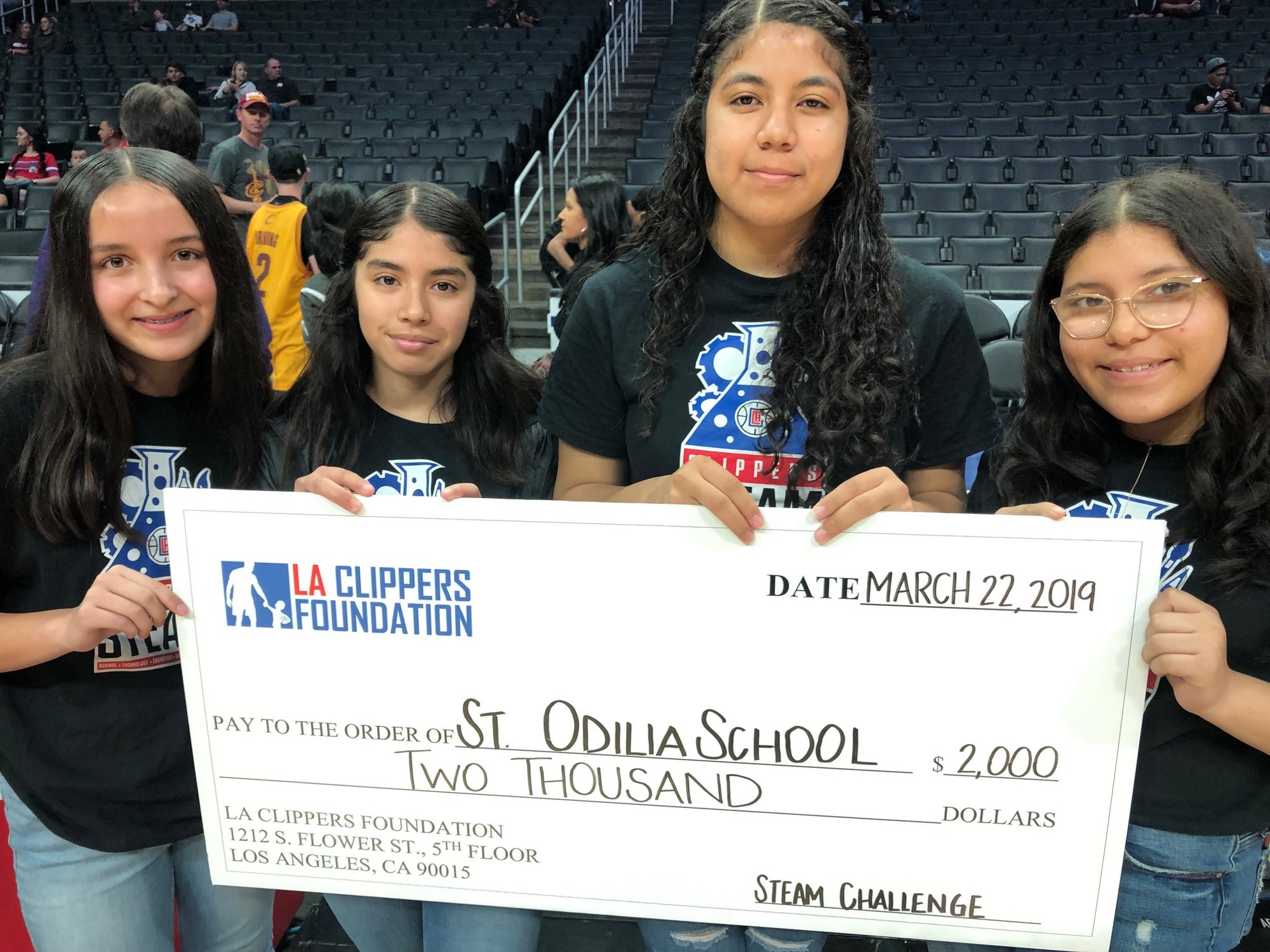 Members of the all-female STEAM team at St. Odilia were presented the middle school category award — and a $2