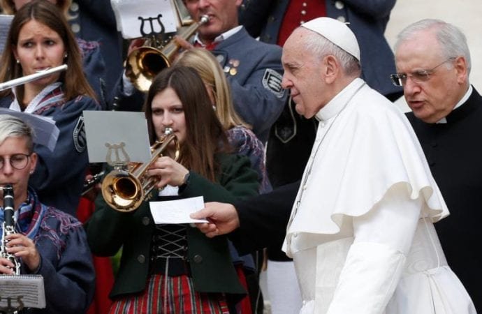 Pope Francis prepares to greet a group of musicians during his general audience in St. Peter's Square at the Vatican May 1