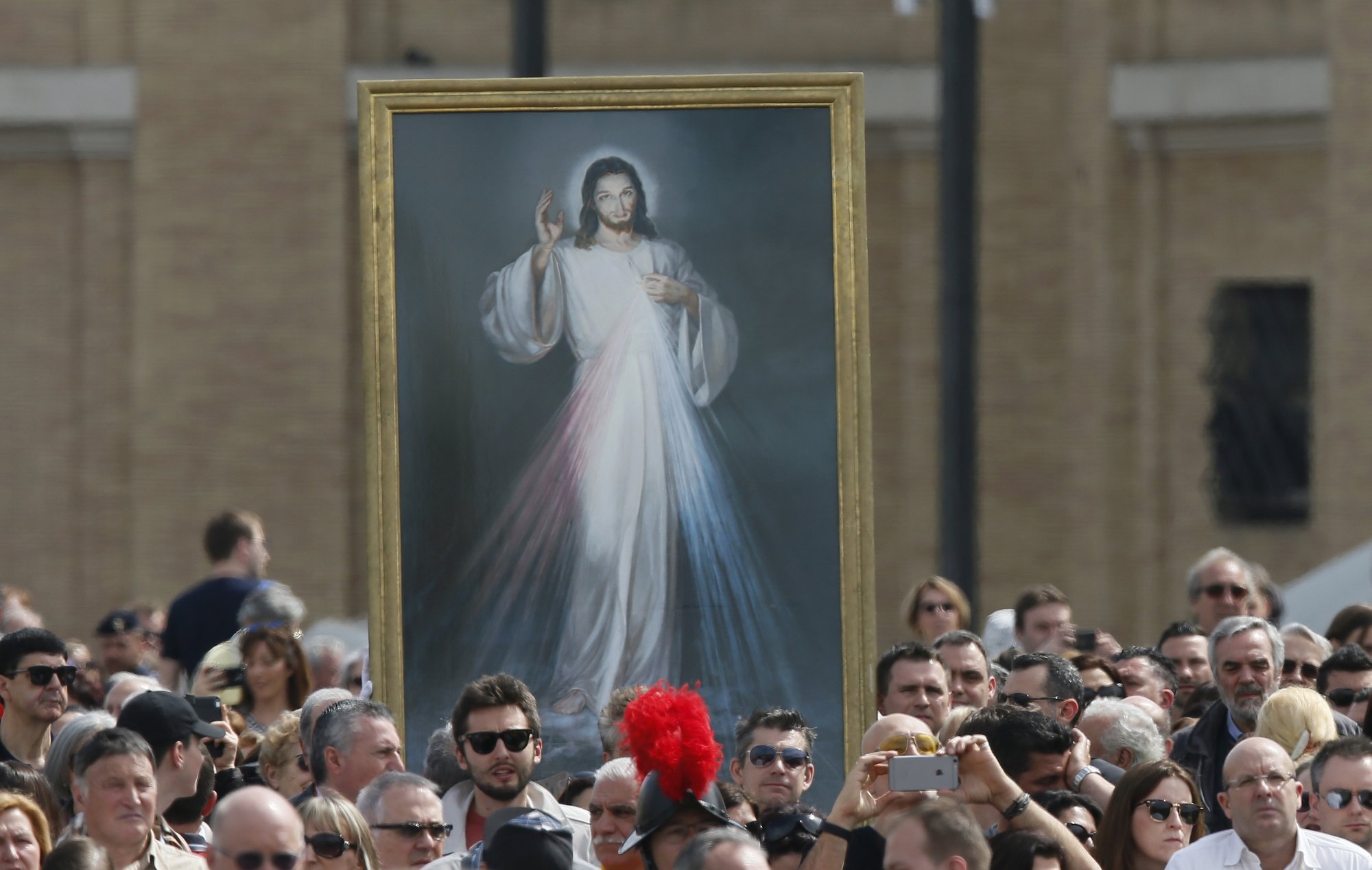 A image of Jesus of Divine Mercy is seen as Pope Francis celebrates Mass on the feast of Divine Mercy in St. Peter's Square in 2016. (CNS photo/Paul Haring)