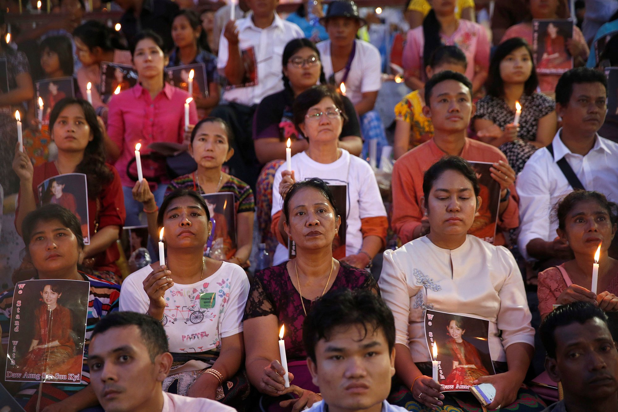 People hold photos of Myanmar state counselor Aung San Suu Kyi during an Oct. 10 candlelight interfaith prayer service in Yangon. Pope Francis will visit Myanmar Nov. 27-30. (CNS PHOTO/SOE ZEYA TUN