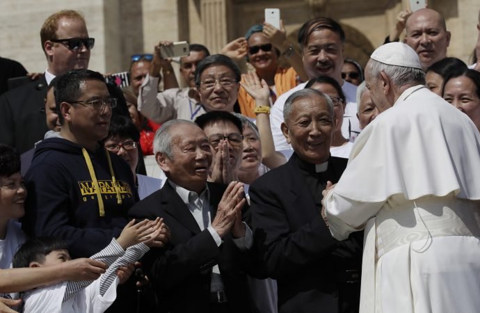 Pope Francis stops by a group of faithful from Shanghai during his weekly general audience in St. Peter's Square at the Vatican