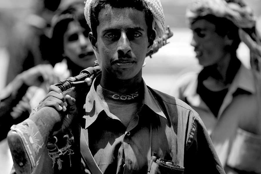 Unidentified young Yemeni man holds a rifle in Aden