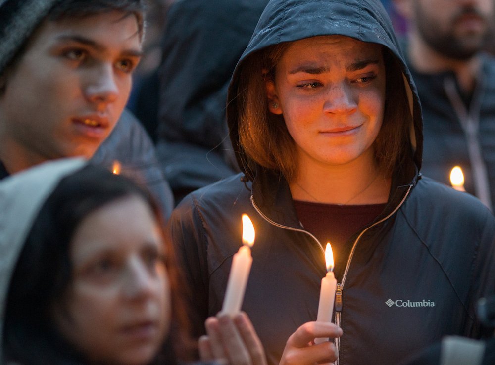 People mourn during a candlelight vigil Oct. 27 for victims of the shooting that killed eleven people at the Tree of Life Synagogue in Pittsburgh. Robert Bowers opened fire that morning during a service at the synagogue