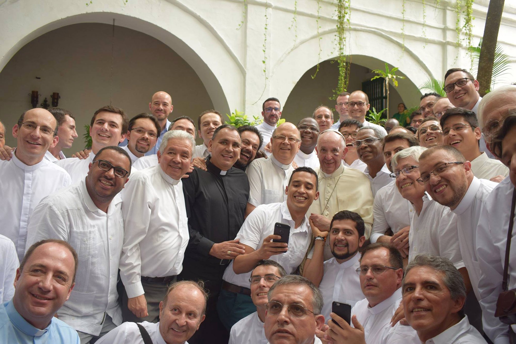 Pope Francis poses for a photo with Jesuit priests and laypeople in Cartagena