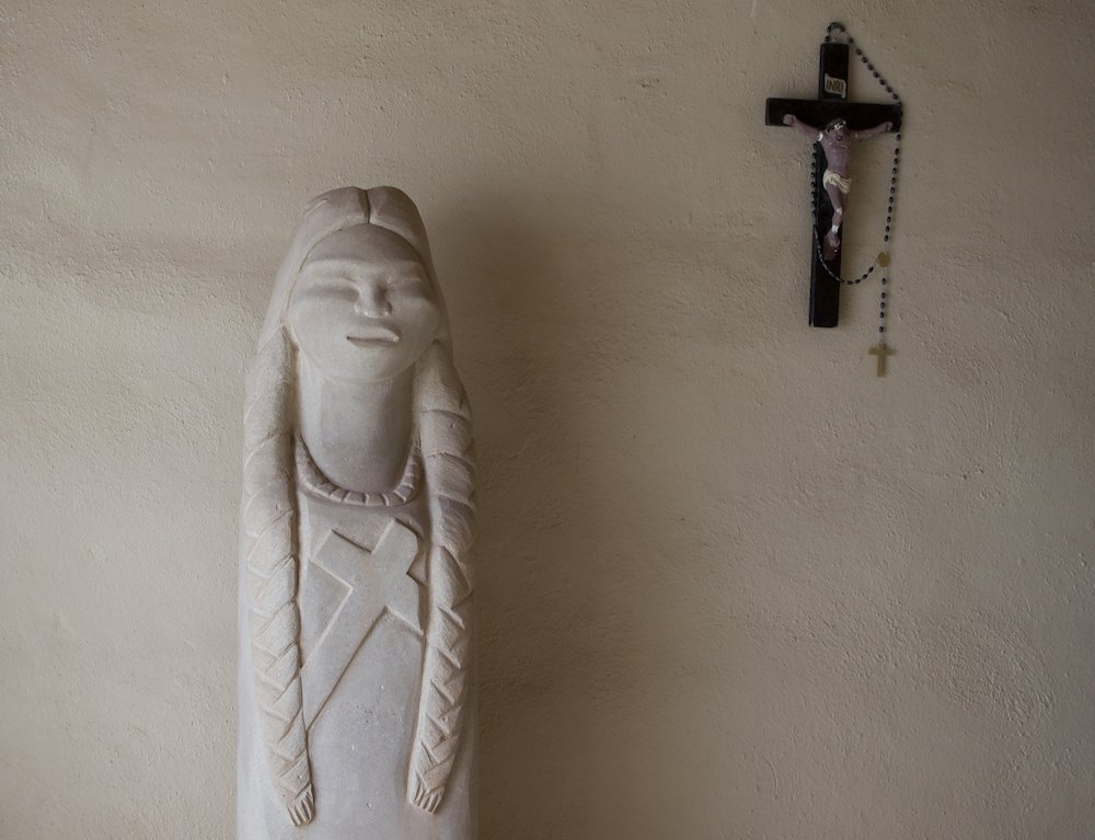 A stone statue of St. Kateri Tekakwitha sits in an alcove of St. Anthony Mission in the Pueblo of Isleta in New Mexico. (CNS photo/Nancy Wiechec)