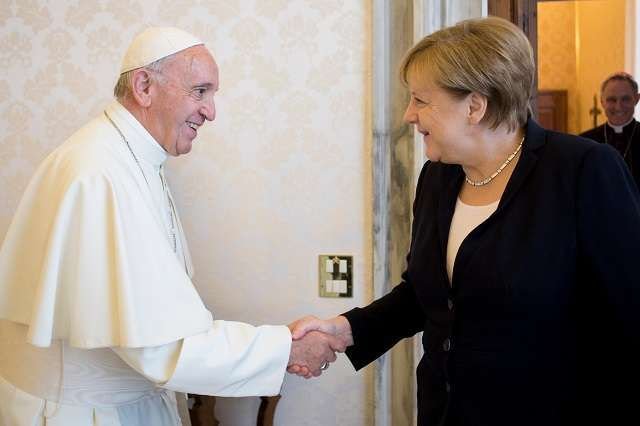Pope Francis shakes hands with German Chancellor Angela Merkel at the Vatican June 17