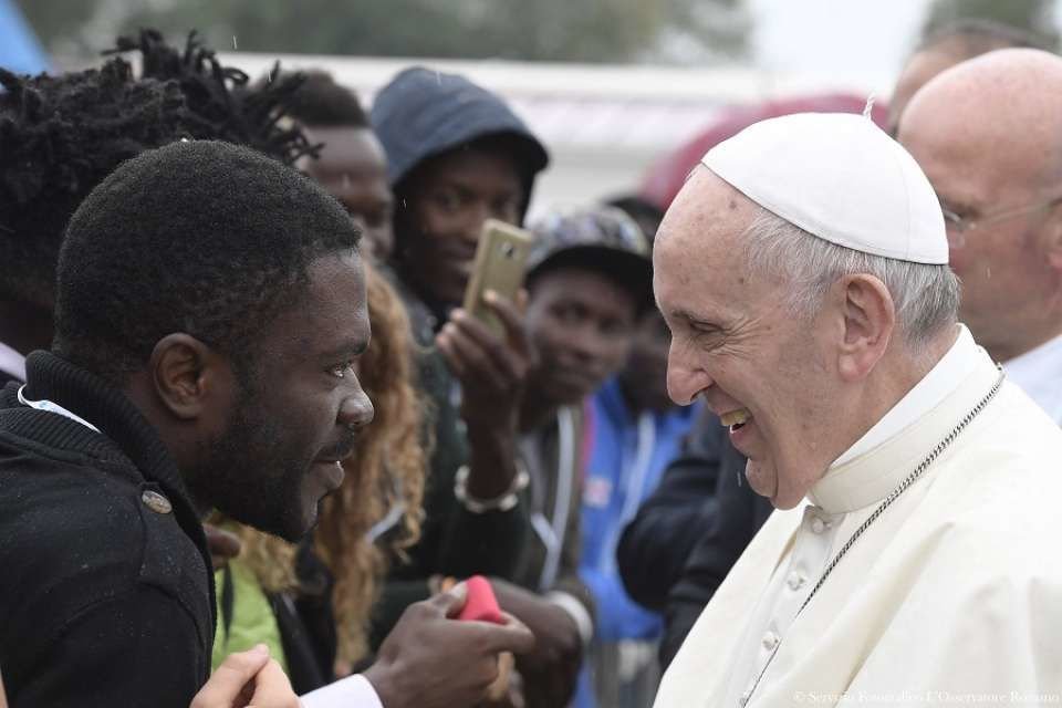 Pope Francis greets migrants at a welcoming hub near Cesena