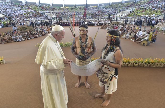 Pope Francis arrives in a coliseum in Puerto Maldonado