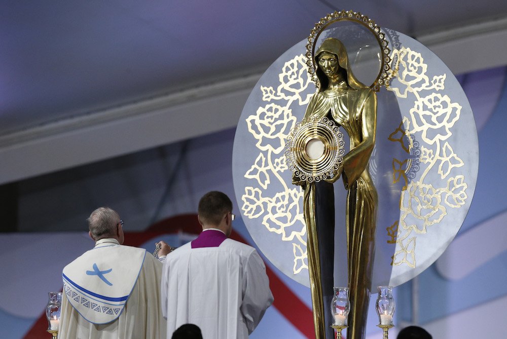 Pope Francis uses incense as he reverences the Eucharist during the World Youth Day prayer vigil at St. John Paul II Field in Panama City Jan. 26