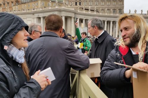 Rome's homeless join volunteers in handing out copies of the Gospel to pilgrims in St. Peter's Square