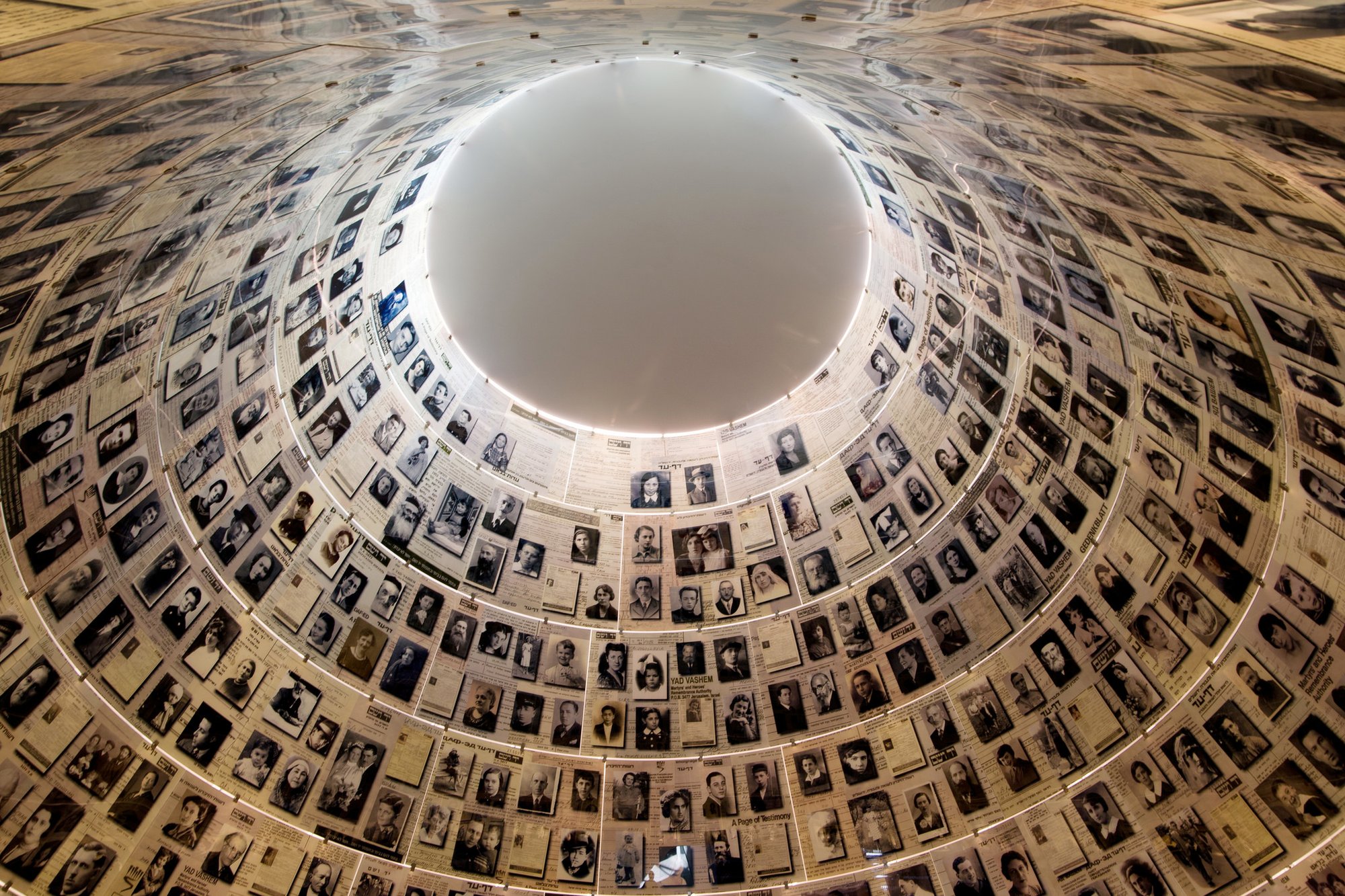 Photos and history of Holocaust victims frame the ceiling of the Hall of Names at Yad Vashem
