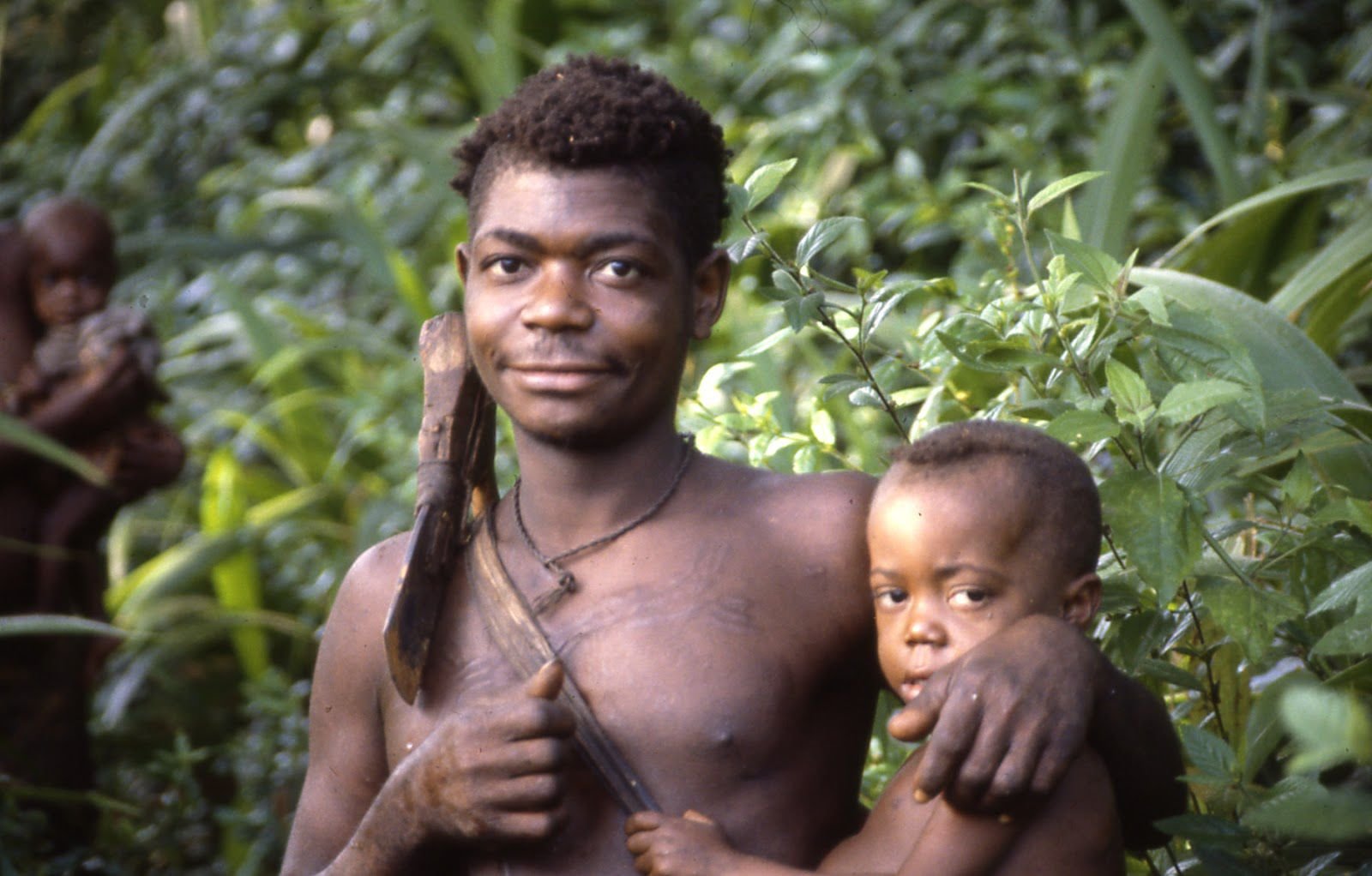 Aka father carrying his daughter while out on a hunt [Credit: Barry Hewlett/The Atlantic]