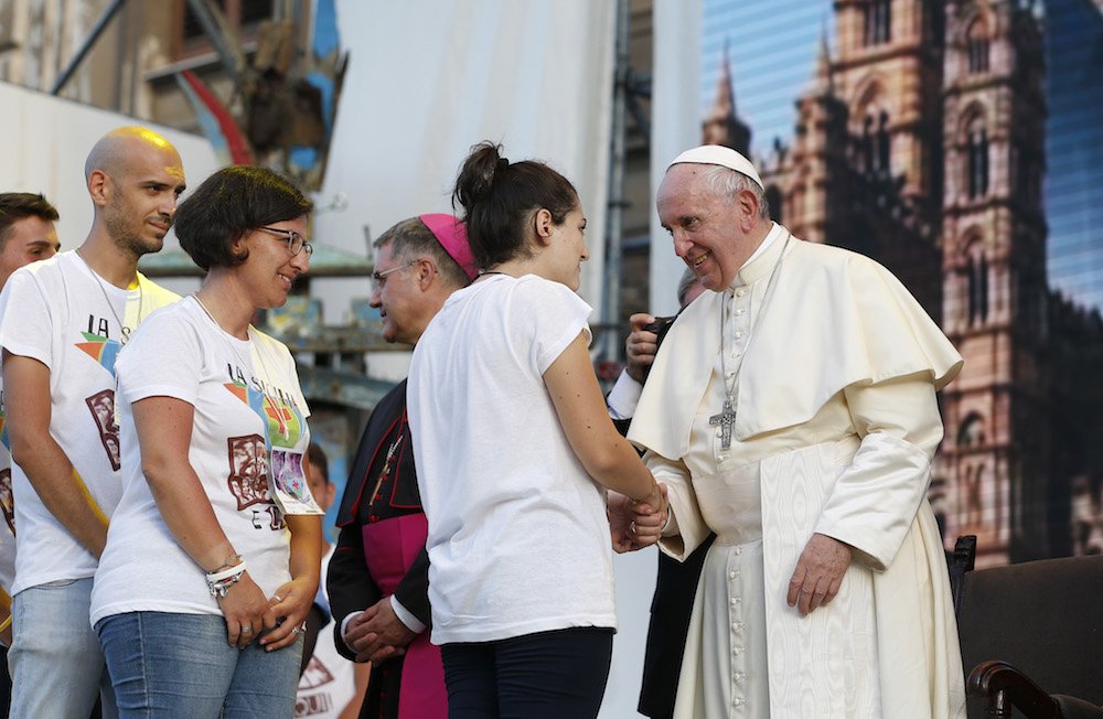 Pope Francis greets a young woman during a meeting with young people in Palermo