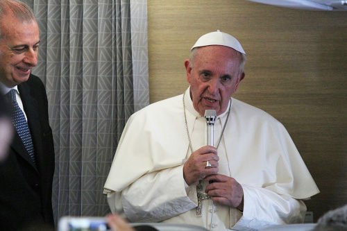 Pope Francis speaks to reporters aboard the papal flight from Africa to Italy
