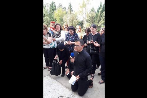 Deacon Momica leads a prayer gathering in Erbil shortly after the Islamic State attack on Telskuf