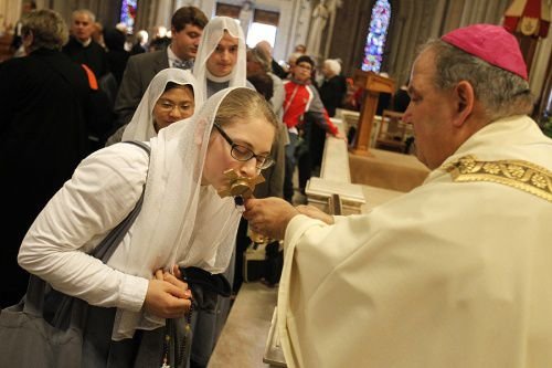 A religious sister kisses the relic of Bl. Miriam Teresa Demjanovich during her beatification ceremony Oct. 4