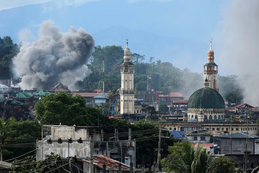 Smoke is seen following a Philippine Army airstrike June 2017, as government troops continued their assault against Islamic militants in Marawi. (CNS photo/Jorge Silva, Reuters)