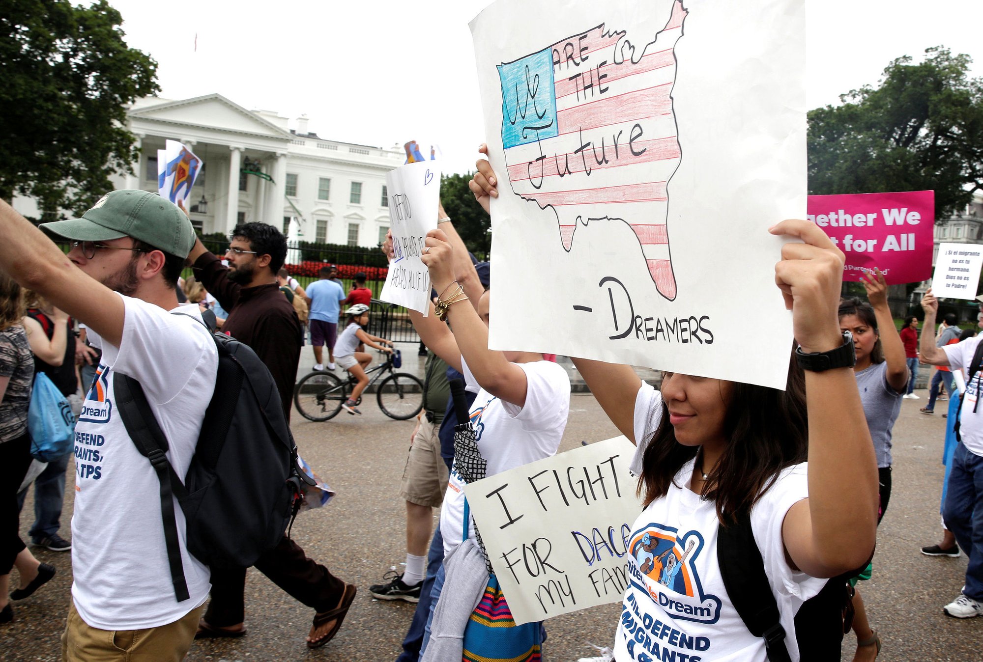 People march outside the White House Aug. 15 at a rally calling on President Donald Trump to protect the Deferred Action for Childhood Arrivals program