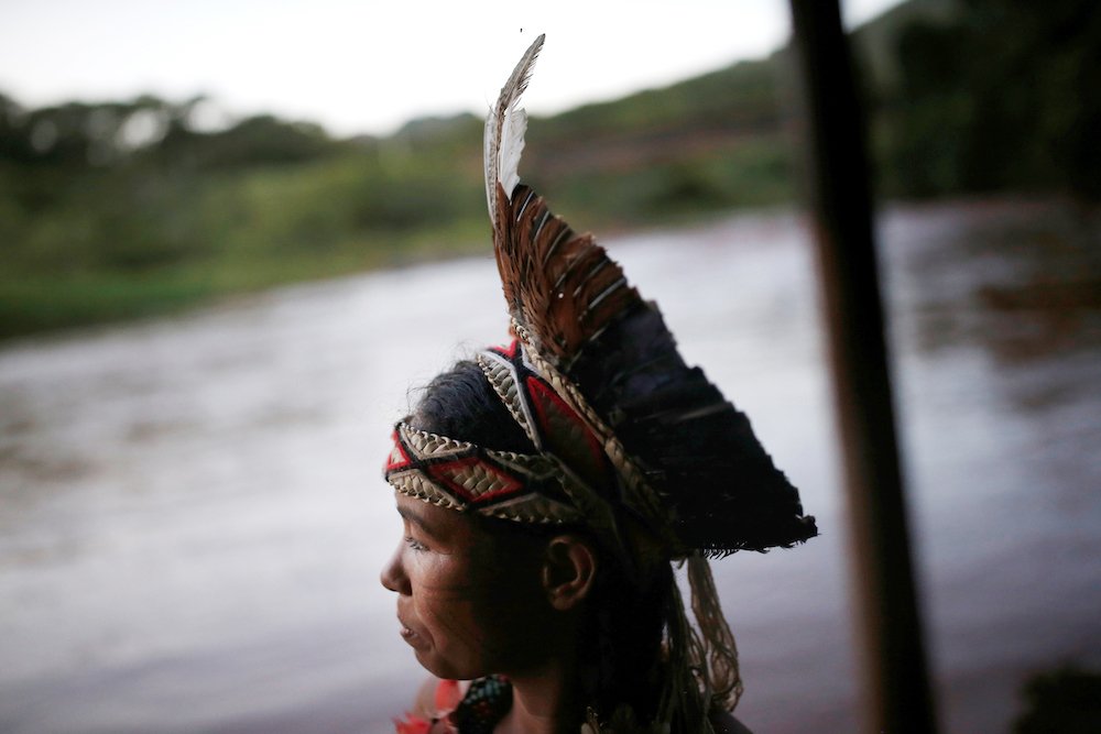 An indigenous woman from the Pataxo Ha-ha-hae tribe looks over the Paraopeba River in Brazil Jan. 28