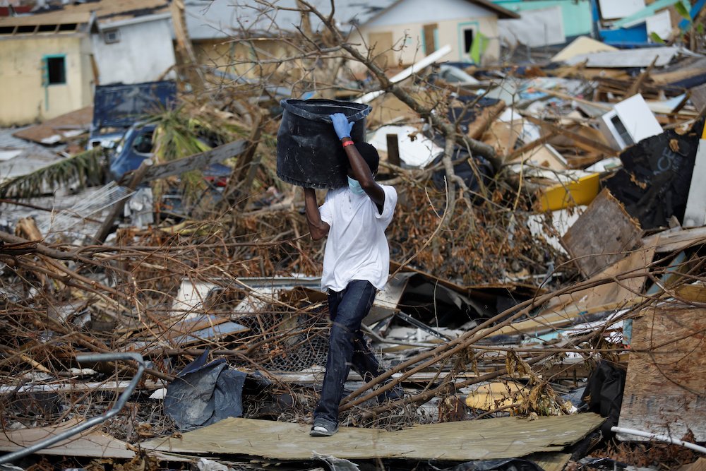 A man removes debris Sept. 10