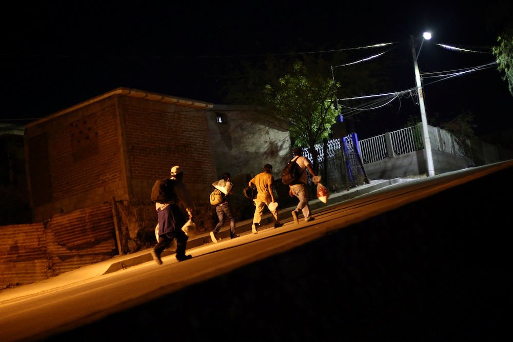 Central American migrants move along a street in Hermosillo